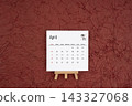 April 2027 calendar on red crumpled paper background. Directly above. 143327068