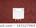 May 2027 calendar on red crumpled paper background. Directly above. 143327069