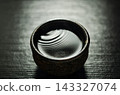 The ripples of sake spreading in the sake cup 143327074
