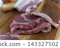 Meat served on a wooden plate 143327502