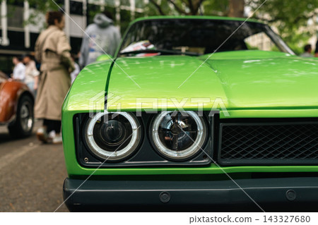 Green classic car headlights at Classic Days Berlin 143327680