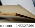 Open book showing blank aged pages, turning a new chapter, concept of learning, education, and literature 143327860