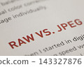 Raw vs. Jpeg file formats comparison text on paper, digital photography image processing explanation 143327876