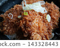 Japanese katsudon topped with green onions 143328443