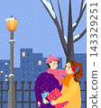 Woman and man holding Christmas gift in snowy park. Couple celebrating winter holiday in city. Romantic evening walk during snowfall by street lamp. Festive surprise and celebration. 143329251