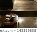 Traditional Japanese tableware and chopsticks placed in a wooden space. 143329838