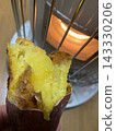 Roasted sweet potatoes on a stove 143330206