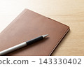 Pocketbook and ballpoint pen 143330402
