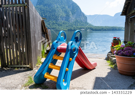 Children Slide on Lake Shore Nature and Water Background in Austria 143331229
