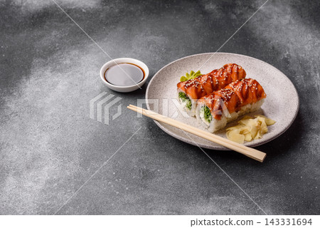 Philadelphia sushi roll with salmon, cream cheese, served with soy sauce. Philadelphia roll Philadelphia sushi roll with salmon, cream cheese, served with soy sauce. Philadelphia roll 143331694