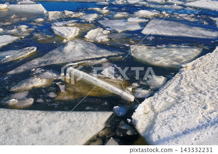 Arctic Blue Melting Ice Floes Floating on Deep Water Surface during Winter Season 143332231