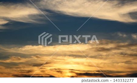 golden sunset with dark contrasting clouds near the horizon line golden sunset with dark contrasting clouds near the horizon line 143332277