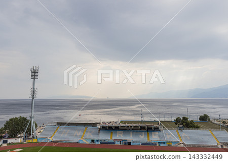 Wide angle view of Rijeka stadium by the sea under cloudy sky in Croatia Wide angle view of Rijeka stadium by the sea under cloudy sky in Croatia 143332449