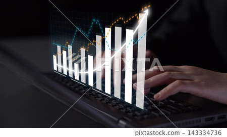 Hands on laptop keyboard with digital graph overlay depicting upward trend in financial growth and analysis, illustrating data success and technology use Copula Hands on laptop keyboard with digital graph overlay depicting upward trend in financial growth and analysis, illustrating data success and technology use Copula 143334736