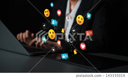 Engaging Female Professional Using Laptop with Colorful Social Media Icons and Notifications Floating Around Her Hands in Dark Environment Gluon Engaging Female Professional Using Laptop with Colorful Social Media Icons and Notifications Floating Around Her Hands in Dark Environment Gluon 143335019