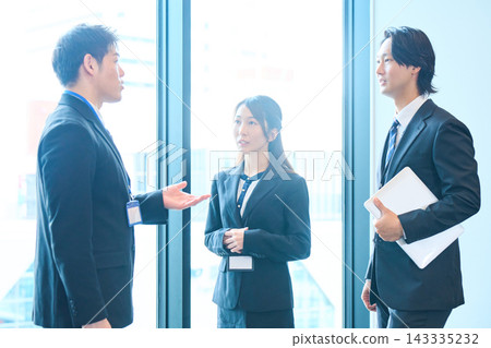 Business people chatting by the window Business people chatting by the window 143335232
