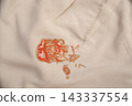 red tomato ketchup stain on khaki fabric. Laundry stain removal concept. 143337554