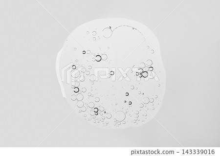 Transparent liquid blob with air bubbles on white background, abstract cosmetic texture Transparent liquid blob with air bubbles on white background, abstract cosmetic texture 143339016
