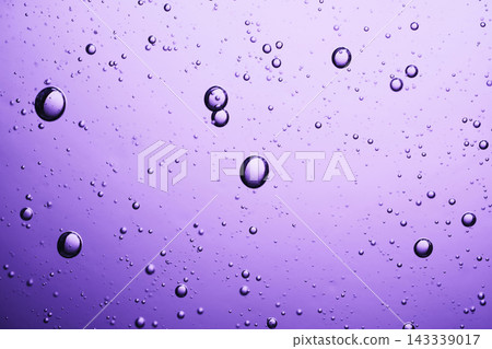 Purple liquid filled with many small and large floating bubbles creating abstract texture Purple liquid filled with many small and large floating bubbles creating abstract texture 143339017