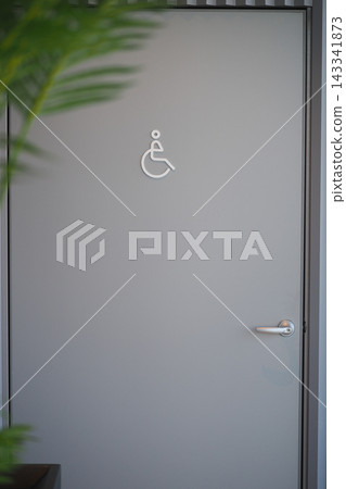 Doorway equipped for handicap accessibility featuring a sign near the entrance Doorway equipped for handicap accessibility featuring a sign near the entrance 143341873
