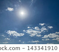 A bright sun and white clouds in the blue sky 143341910