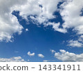 White clouds surrounding a blue sky 143341911