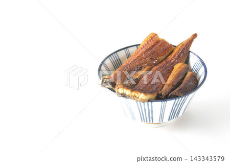 A single serving of eel rice bowl photographed against a white background. A single serving of eel rice bowl photographed against a white background. 143343579