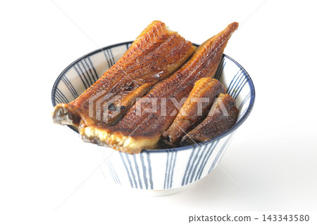 A single serving of eel rice bowl photographed against a white background. 143343580