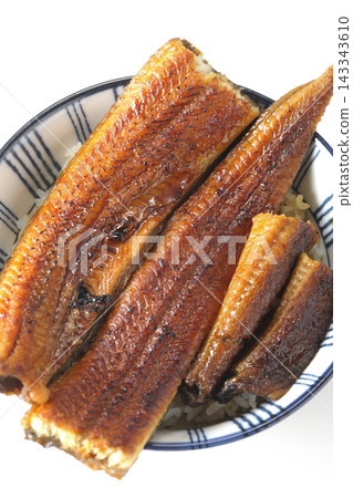 A single serving of eel rice bowl photographed against a white background. A single serving of eel rice bowl photographed against a white background. 143343610