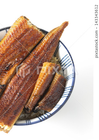 A single serving of eel rice bowl photographed against a white background. A single serving of eel rice bowl photographed against a white background. 143343612