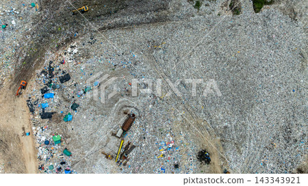 Garbage pile in trash dump or landfill abundance, Aerial view garbage truck unload garbage to a landfill, Biohazard global warming ecosystem and healthy environment concept. Garbage pile in trash dump or landfill abundance, Aerial view garbage truck unload garbage to a landfill, Biohazard global warming ecosystem and healthy environment concept. 143343921