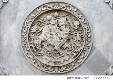 Ornate Stone Qilin Relief Carving in Circular Chinese Medallion Decoration on Temple Wall 143344349
