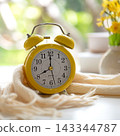 Early Work day.  Alarm clock on bed in morning relax for wellness life with sun light. 143344787