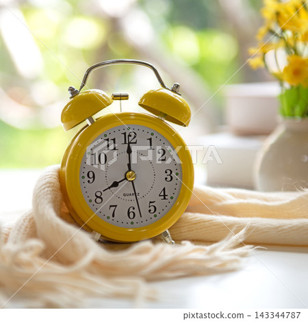 Early Work day. Alarm clock on bed in morning relax for wellness life with sun light. Early Work day. Alarm clock on bed in morning relax for wellness life with sun light. 143344787
