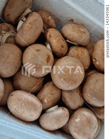 A lot of button mushrooms piled up. A lot of button mushrooms piled up. 143345061