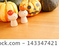 Peg dolls with mini pumpkins on top and Halloween pumpkins 143347421