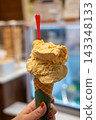 Pistachio gelato in a cone. 143348133