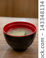 Miso soup with seaweed in a black cup, Japanese food. on the wooden table 143348134