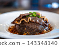 Beef fat fried rice topped with sliced medium rare picanha steak 143348140