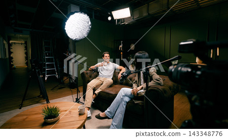 Podcast hosts creating content in recording studio Podcast hosts creating content in recording studio 143348776