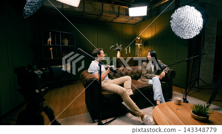 Content creators conducting podcast interview in studio Content creators conducting podcast interview in studio 143348779