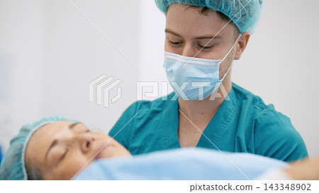 Medical professional attending patient in operating room 143348902