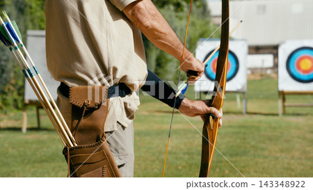 Archery man aiming bow at targets reaching goals Archery man aiming bow at targets reaching goals 143348922