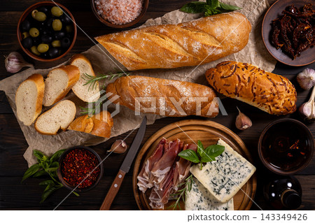 Assorted antipasto ingredients creating a rustic spread Assorted antipasto ingredients creating a rustic spread 143349426