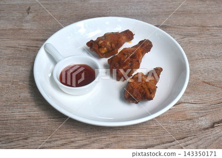 grilled chicken drumstick dipping sweet tomato sauce arranging on plate grilled chicken drumstick dipping sweet tomato sauce arranging on plate 143350171