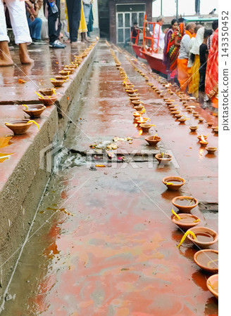 Oil Lamps (Diyas) Lined Along River Ghat During Ritual in Mathura Oil Lamps (Diyas) Lined Along River Ghat During Ritual in Mathura 143350452