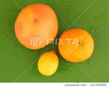 fresh orange on a green background fresh orange on a green background 143350900