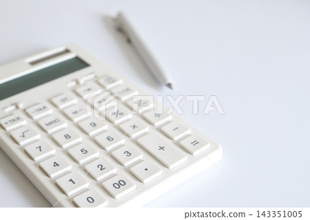 A calculator and ballpoint pen for managing household finances. A calculator and ballpoint pen for managing household finances. 143351005
