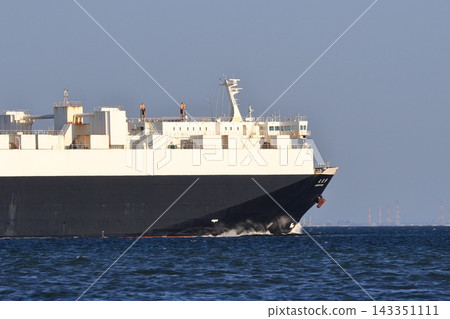 A large cargo ship sailing through Tokyo Bay 143351111