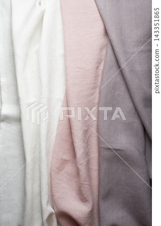 Draped Pastel Linen Fabric Texture in Pink, White, and Lilac Draped Pastel Linen Fabric Texture in Pink, White, and Lilac 143351865